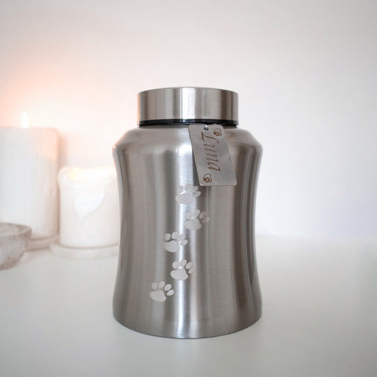 Traditional brushed metal pet urn personalised with pet name on dog tag, embossed with paw prints