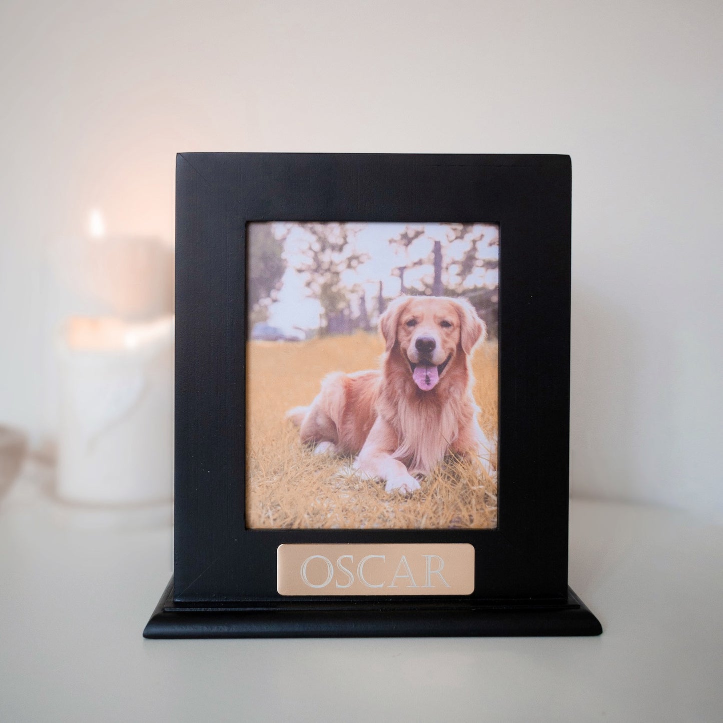 A simple but elegant wooden urn showcasing your pet with a dedicated space for their photo, allowing you to celebrate your pet's unique spirit. This urn is a timeless, elegant design and would look good in any niche or spot in any household. We also include an engraved gold plaque with your treasured pet's name.
There is also the option of omitting the photo and replacing with your pets ink paw print. Just as personal and entirely your choice.