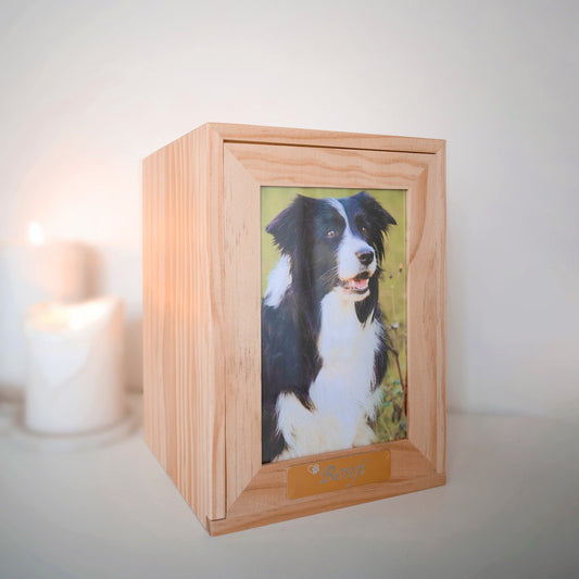 A simple but elegant wooden urn showcasing your pet with a dedicated space for their photo, allowing you to celebrate your pet's unique spirit. This urn is a timeless, elegant design and would look good in any niche or spot in any household. We also include an engraved gold plaque with your treasured pet's name.
There is also the option of omitting the photo and replacing with your pets ink paw print. Just as personal and entirely your choice.