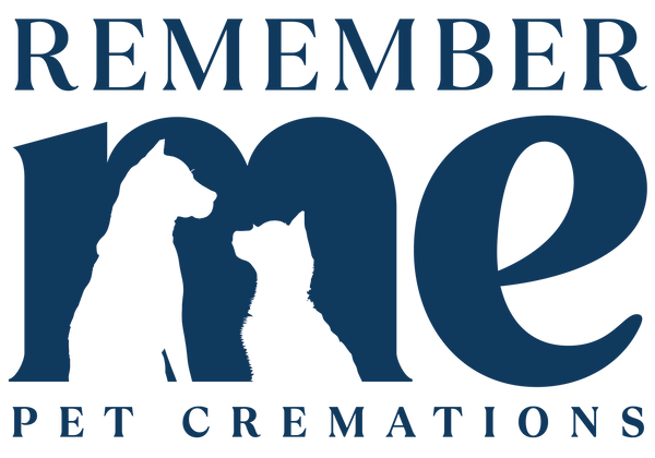 Logo for "Remember Me Pet Cremations". The words "REMEMBER ME" are written in large, Navy-coloured capital letters, with the letters "m" and "e" stylised to form the silhouette of a dog and a cat facing each other inside the "m". The phrase "PET CREMATIONS" appears below in smaller capital letters. The entire design is set against a black background.