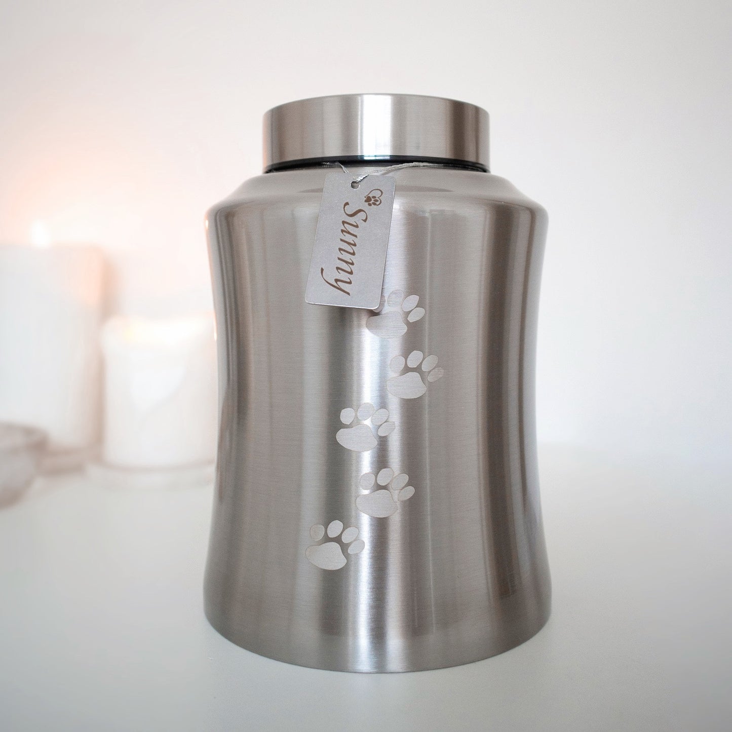 Traditional brushed metal pet urn personalised with pet name on dog tag, embossed with paw prints